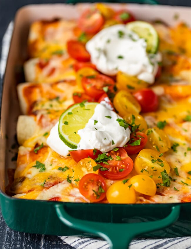 Shredded Beef Enchiladas are the perfect thing to serve for dinner. This is the best beef enchilada recipe I've ever had! They're filled with the most flavorful shredded beef, and topped with sour cream, cheese, tomatoes, and more. Make this amazing beef enchiladas recipe right away!