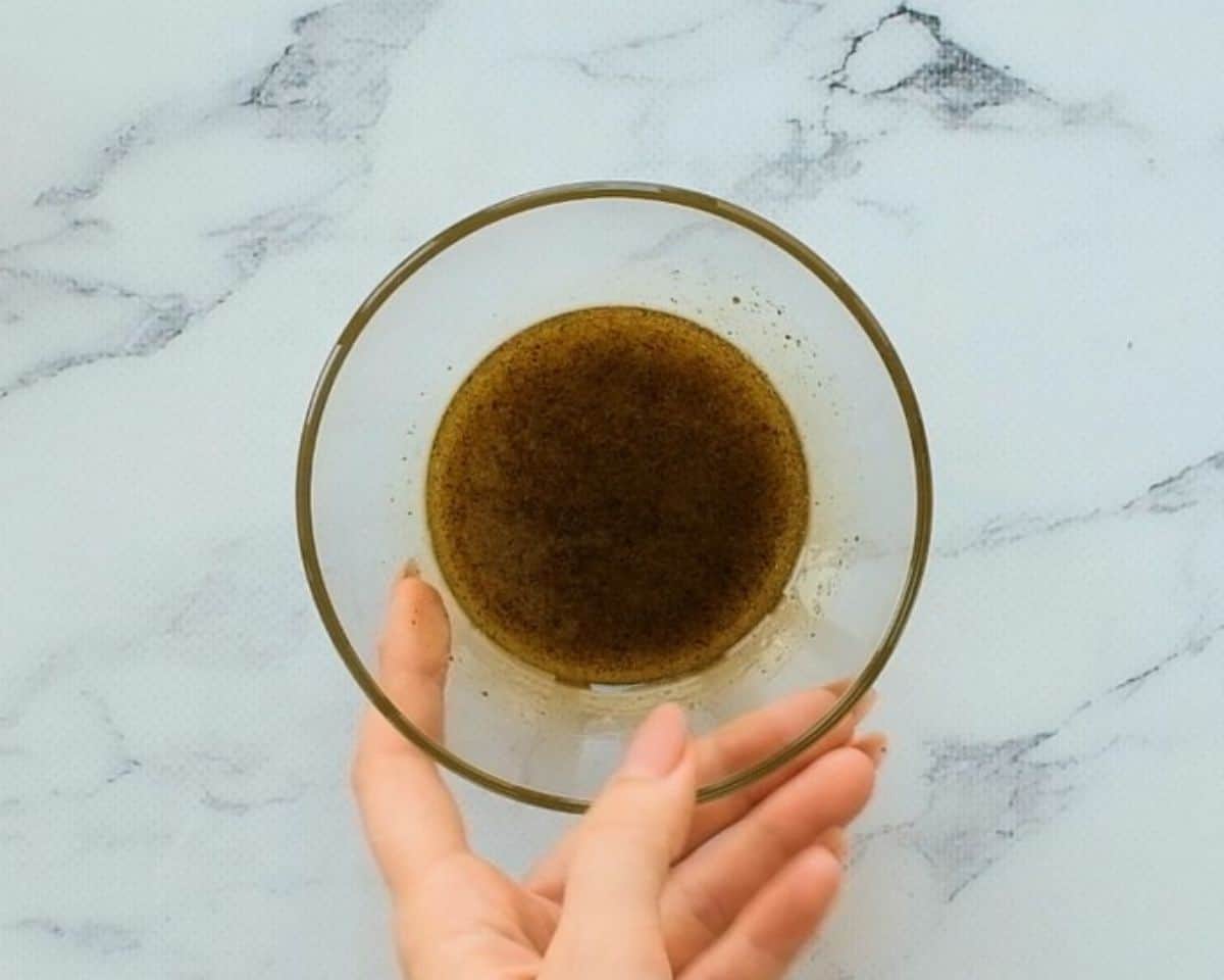Olive oil dressing in a glass bowl.