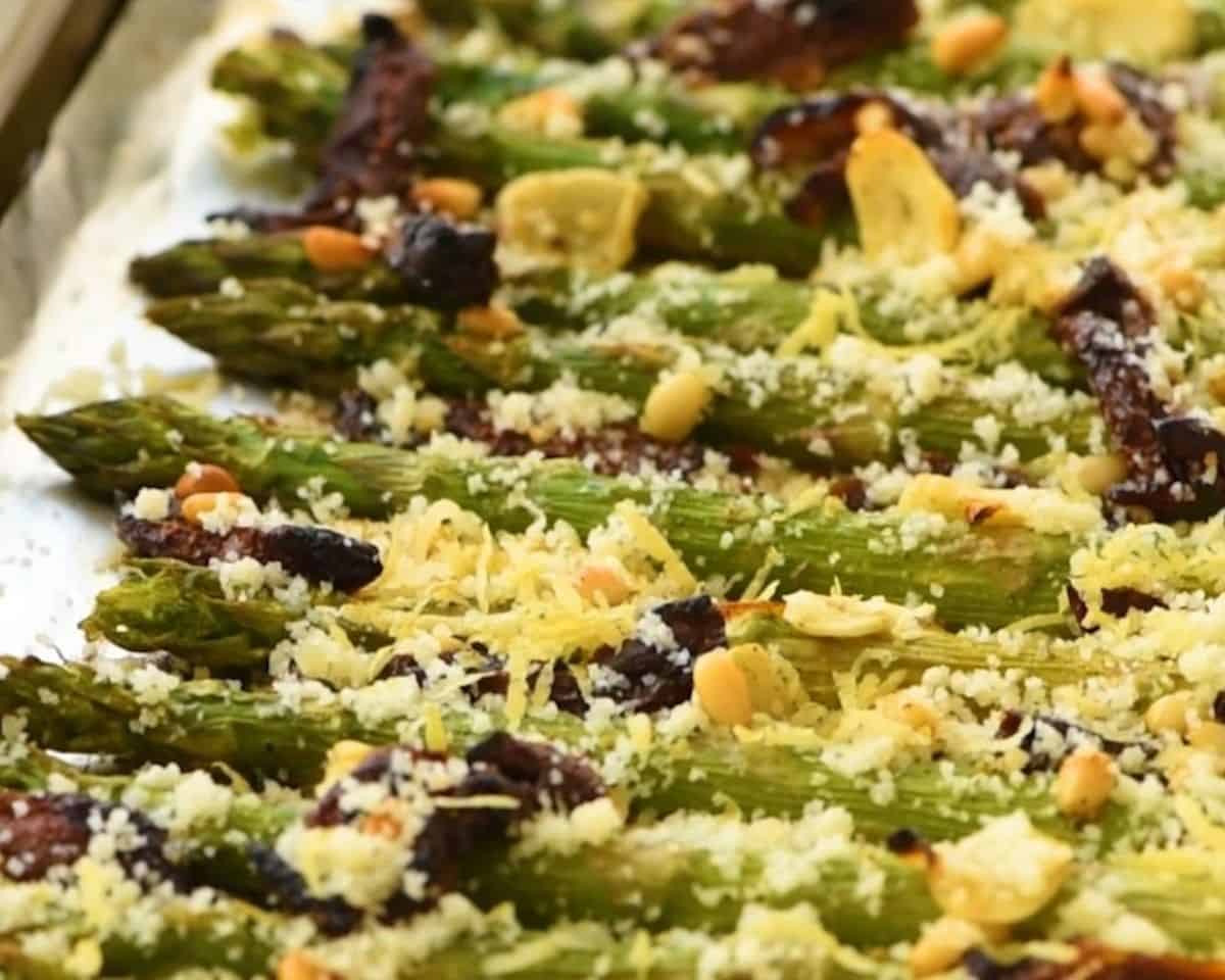 Asparagus with sundried tomatoes, Parmesan, pine nuts, and lemon zest.