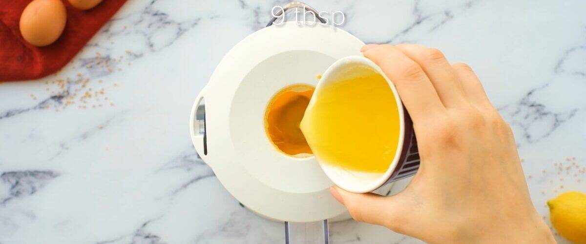 Pouring melted butter into the blender.