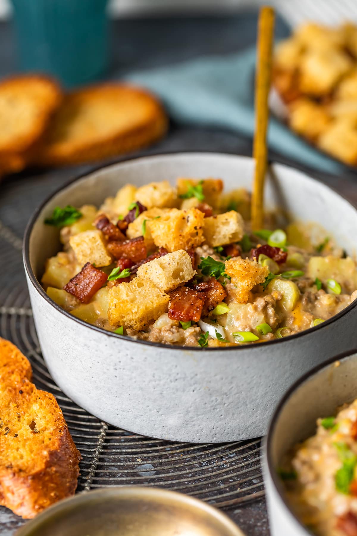 bowl of soup topped with bacon and croutons