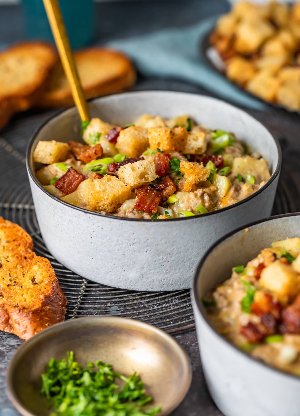 bowls of cheeseburger soup topped with croutons