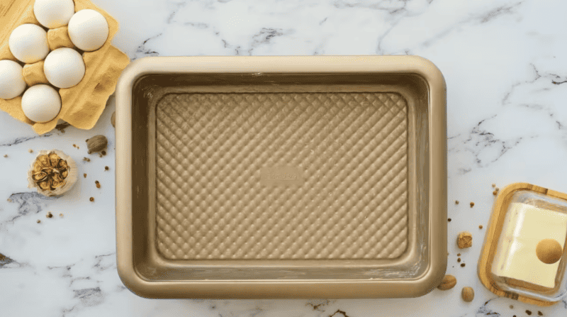 a metal casserole dish brushed with butter.