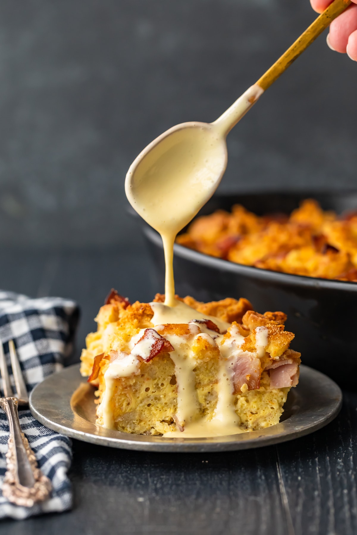 eggs benedict casserole topped with hollandaise sauce