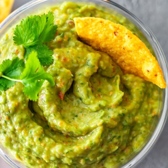 Easy Guacamole Recipe...I've never heard three words sound more beautiful! This simple and delicious Food Processor Guacamole is filled with great ingredients, and only takes a few minutes to make. No chunks here, just smoooooth guac!