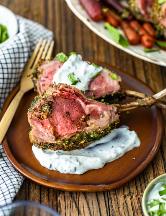 Rack of Lamb is an elegant option for holidays and special occasions. This delicious Herb Crusted Rack of Lamb recipe is simple yet filled with incredible flavor! The Mint Yogurt Sauce is the perfect compliment to the savoriness of this dish. Try this roast rack of lamb for a beautiful Easter Dinner!