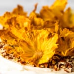 Dried Pineapple Flowers are a surprisingly easy way to make any cake look like it was decorated by a professional! Learn how to make flowers for cake out of pineapple, and every cake will look extra amazing for holidays and special occasions. Plus these dried pineapple slices make a great snack!