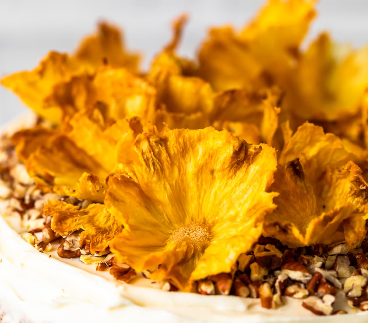 Dried Pineapple Flowers are a surprisingly easy way to make any cake look like it was decorated by a professional! Learn how to make flowers for cake out of pineapple, and every cake will look extra amazing for holidays and special occasions. Plus these dried pineapple slices make a great snack! dried pineapple flowers