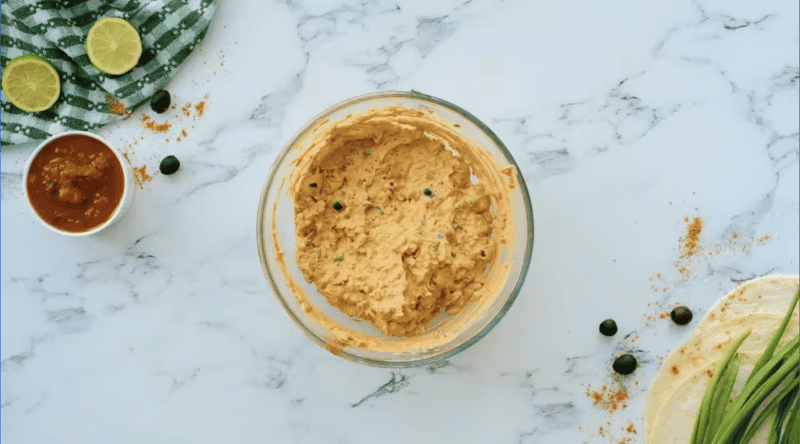 sausage studded cream cheese in a glass bowl.