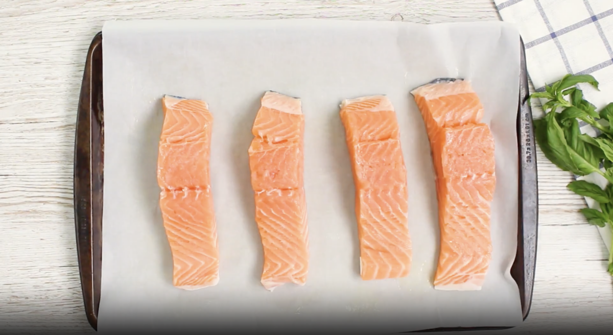 4 salmon filets on a baking sheet.