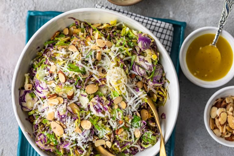 A beautifully presented photo of Shaved Brussels Sprout Salad with Honey Lemon Dijon Vinaigrette