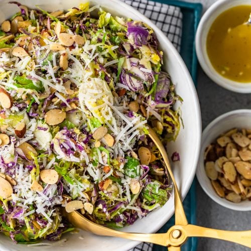 Shaved Brussels Sprout Salad is a simple side dish to serve with any meal. Brussels Sprouts, toasted almonds, and cheese are tossed with a Honey Lemon Dijon Vinaigrette for a light and delicious flavor. This shaved Brussels Sprouts recipe is so easy and can be made in no time!