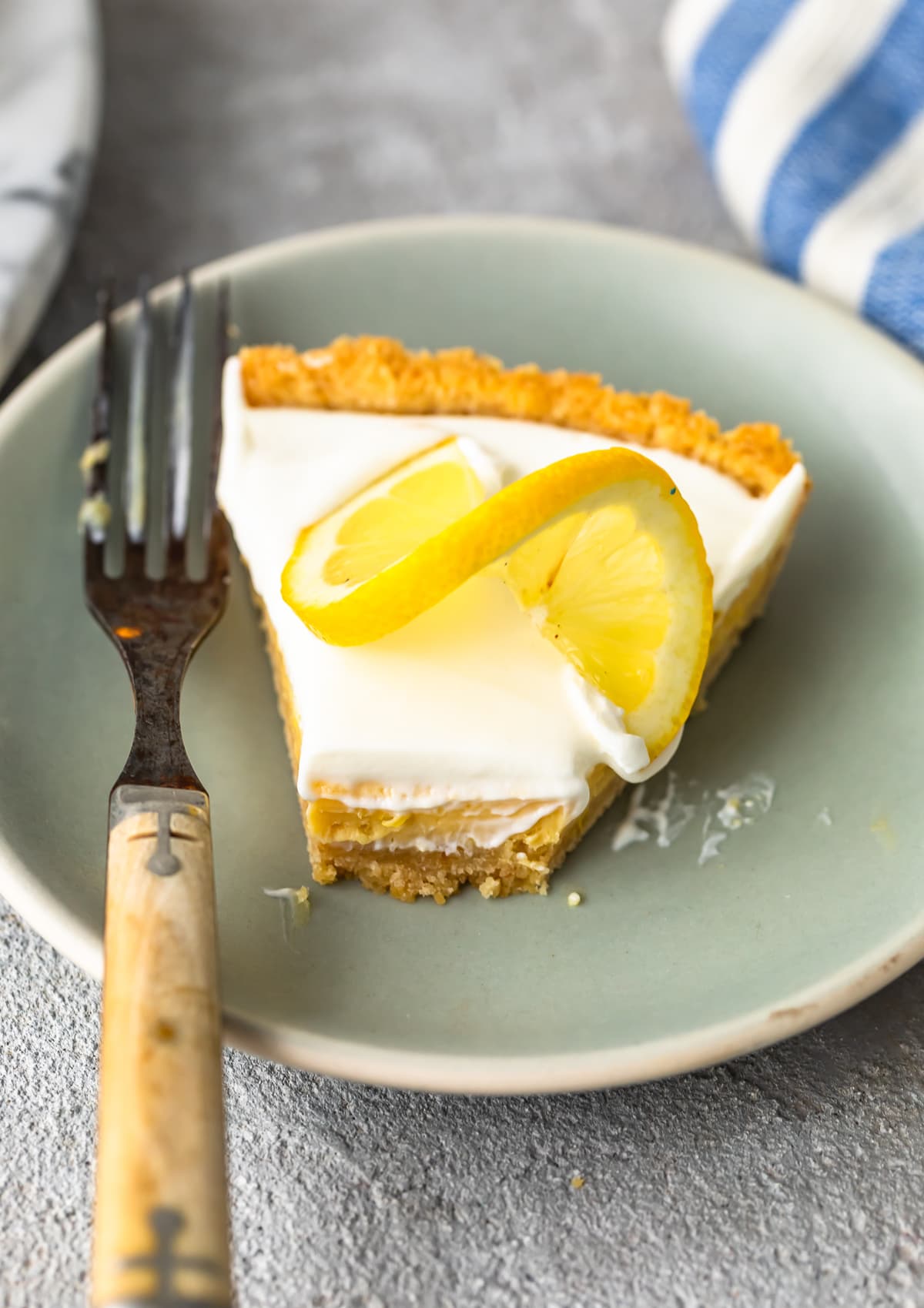 slice of lemon pie topped with sour cream and lemon slice