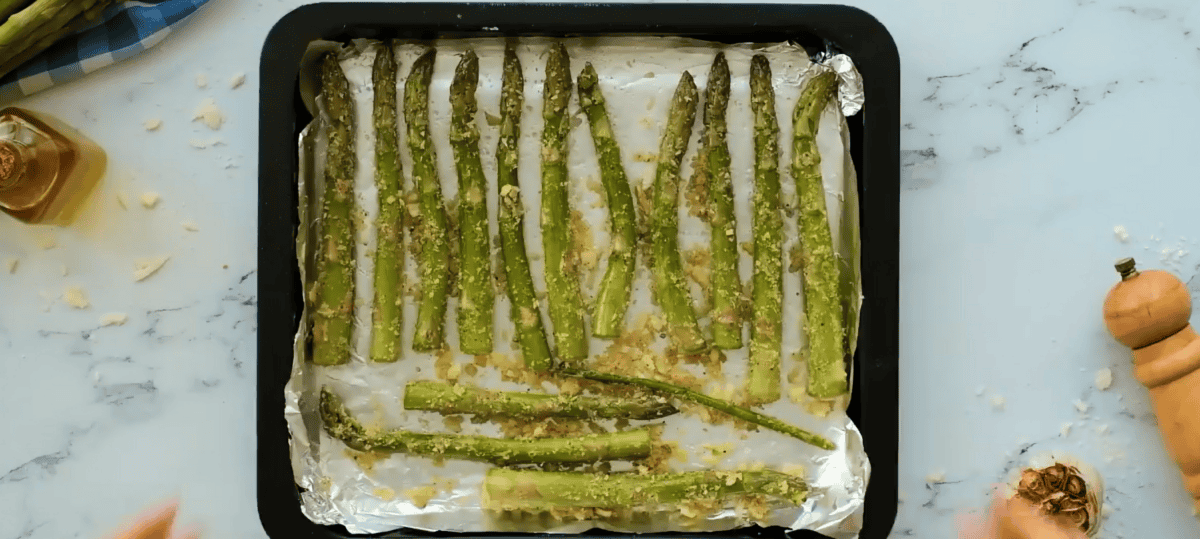 garlic asparagus on a baking sheet lined with aluminum foil