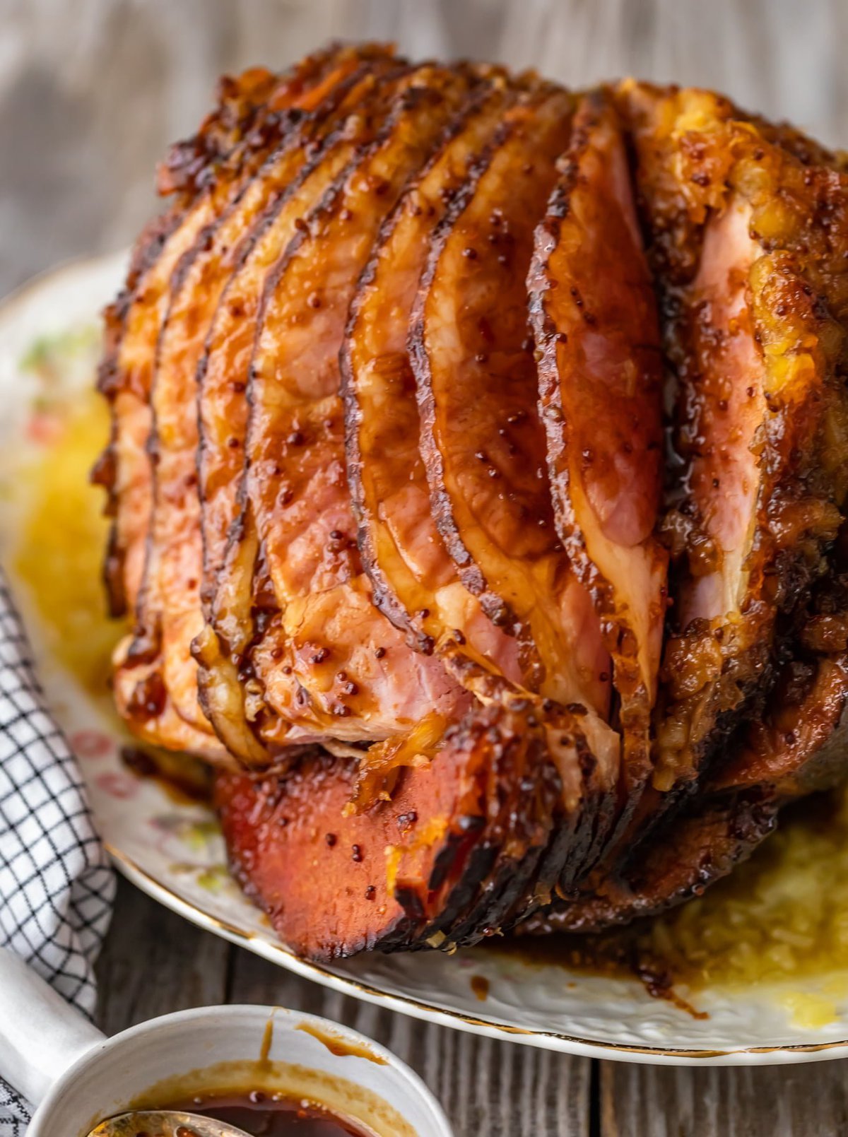 This Brown Sugar Pineapple Ham is the perfect Easter Ham recipe! We made a delicious cola and brown sugar glaze for ham, and combined it with crushed pineapples. This spiral ham is easy to make, and filled with SO much flavor! spiral ham sliced