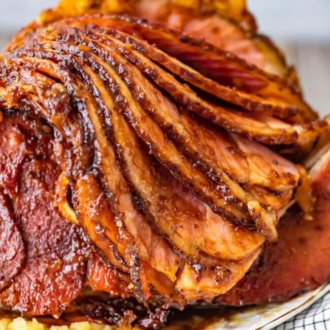 This Brown Sugar Pineapple Ham is the perfect Easter Ham recipe! We made a delicious cola and brown sugar glaze for ham, and combined it with crushed pineapples. This spiral ham is easy to make, and filled with SO much flavor!