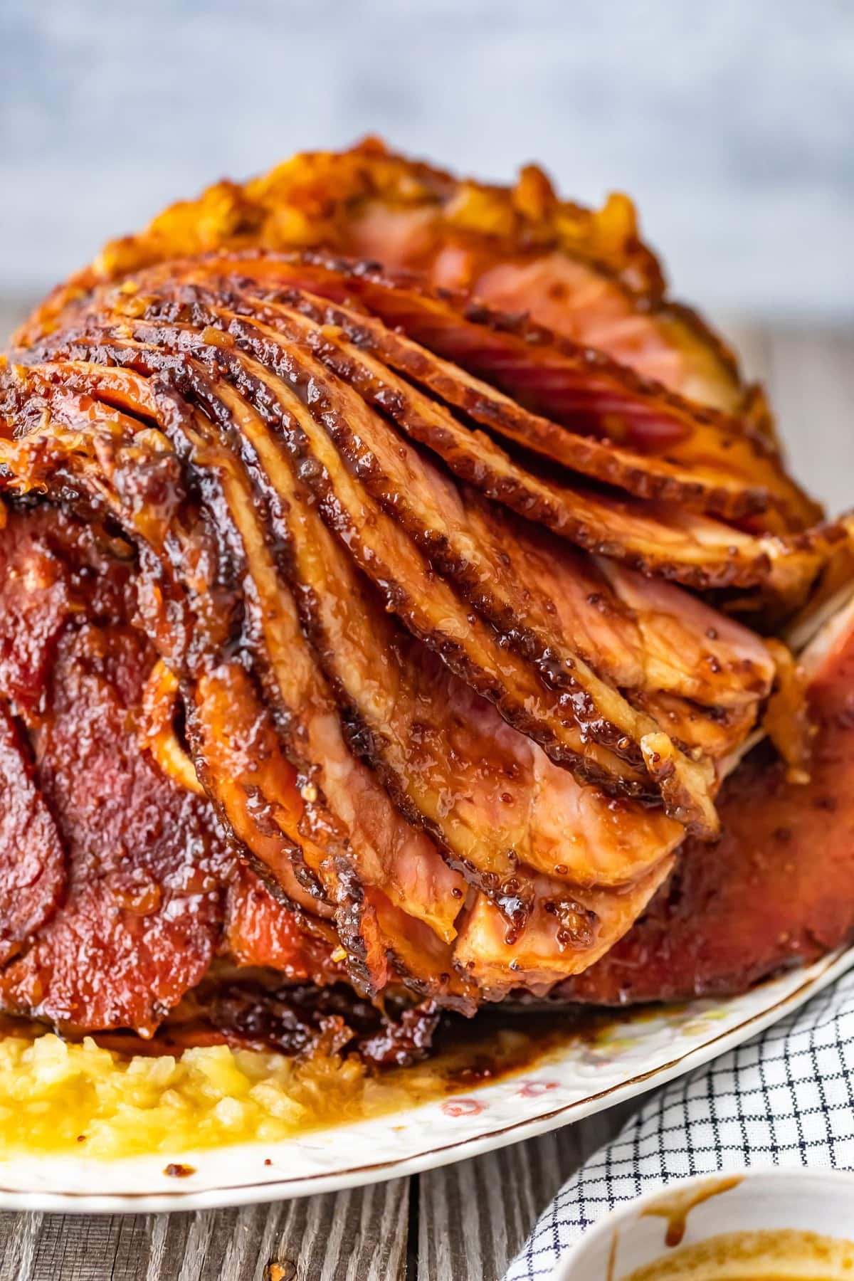 This Brown Sugar Pineapple Ham is the perfect Easter Ham recipe! We made a delicious cola and brown sugar glaze for ham, and combined it with crushed pineapples. This spiral ham is easy to make, and filled with SO much flavor!