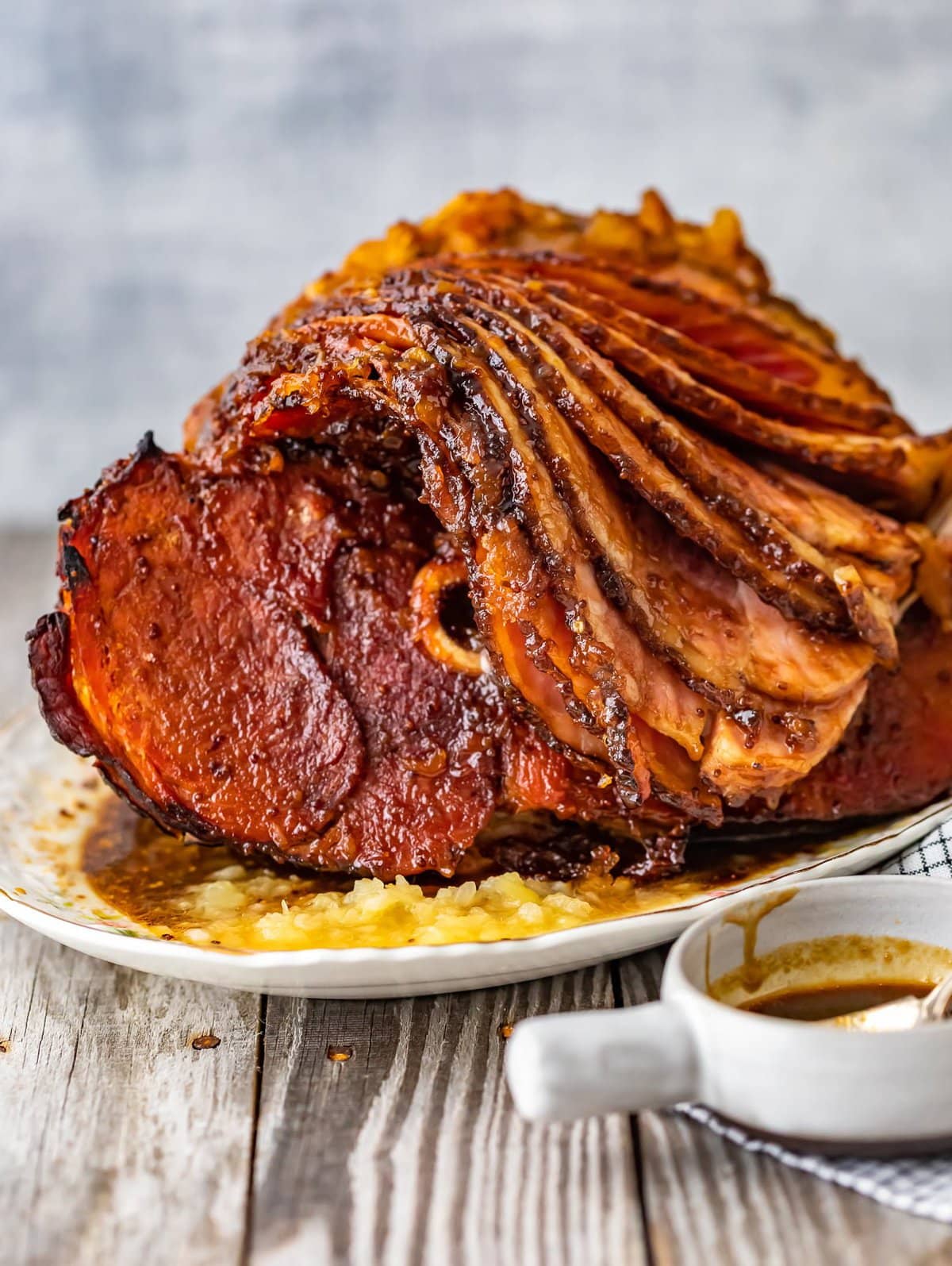 This Brown Sugar Pineapple Ham is the perfect Easter Ham recipe! We made a delicious cola and brown sugar glaze for ham, and combined it with crushed pineapples. This spiral ham is easy to make, and filled with SO much flavor! brown sugar and pineapple ham