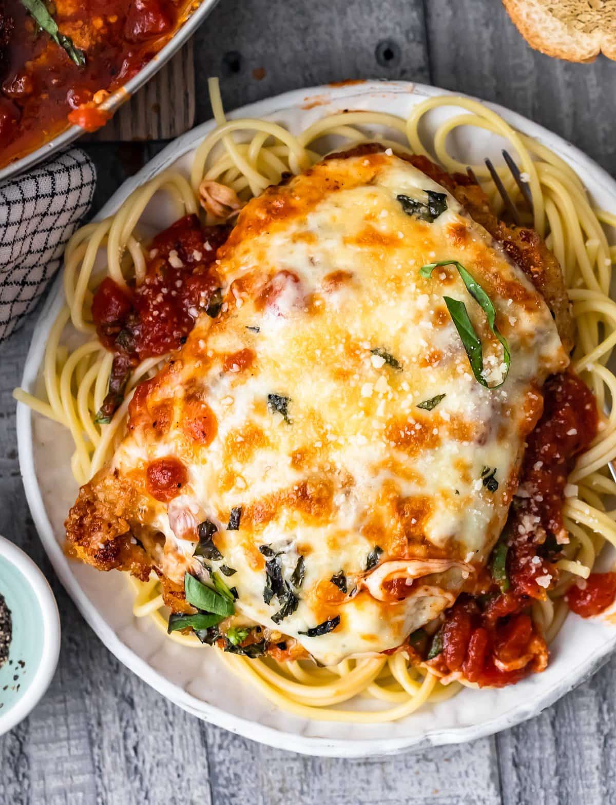 a plate of chicken parmesan with spaghetti