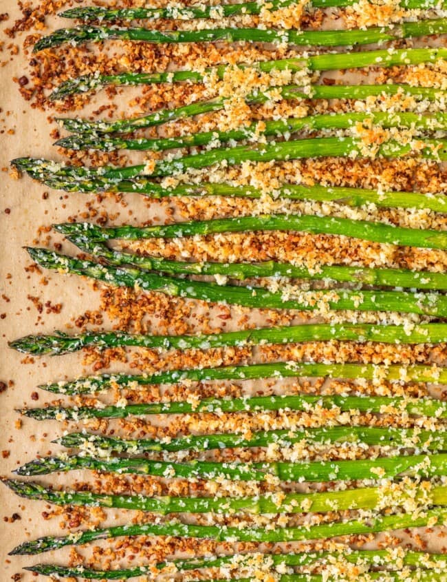 Garlic Asparagus is an easy side dish for any meal. This CRISPY garlic roasted asparagus recipe is both healthy and flavorful. Baked with panko breadcrumbs, garlic, cheese, and olive oil, this is a dish everyone is sure to love. If that's not enough, our garlic parmesan asparagus is topped off with homemade garlic aioli!