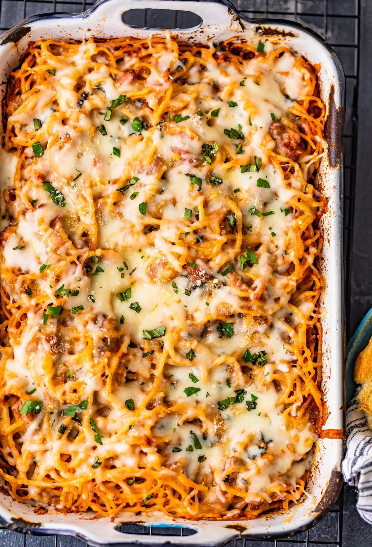 baking dish filled with spaghetti and covered with cheese