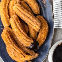 Churros are one of the best treats ever, and this easy churros recipe means you can make them at home any time you want. Better yet, they're gluten free! Dip these fried cinnamon sugar snacks in chocolate sauce for the ultimate delight!