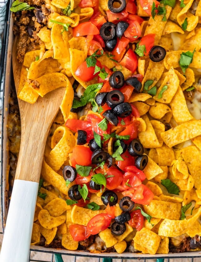 Frito Pie Casserole is an easy recipe with all the best Tex Mex flavors! Layer up the corn chips, beef, cheese, and more in a delicious dish that's perfect for weeknight dinners. Everyone will LOVE this Frito Pie recipe!
