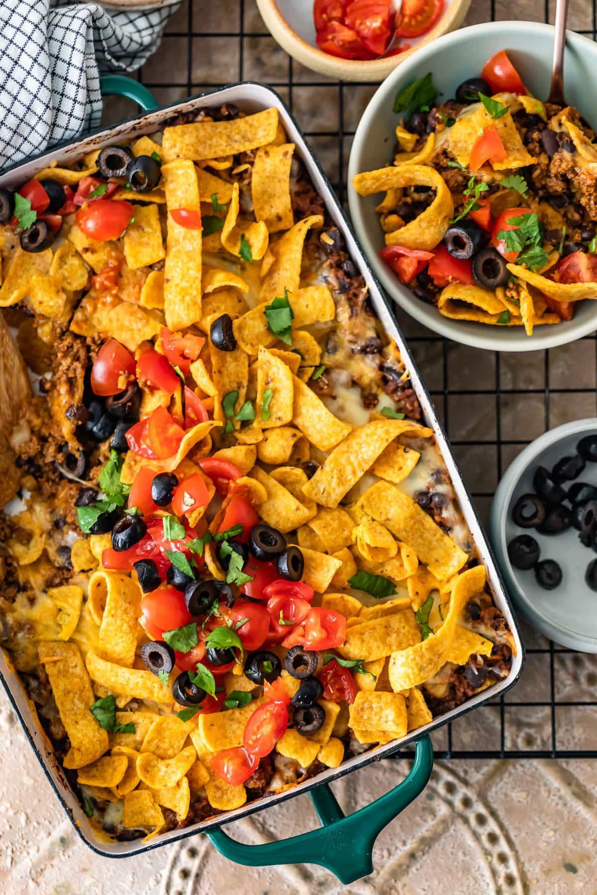 frito pie casserole next to a bowl of frito pie