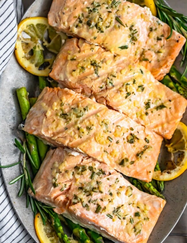 Garlic Butter Salmon is a simple and healthy dish you'll want to be making all summer long! This easy grilled salmon recipe is one of the best and most flavorful. The garlic lemon butter salmon is so light and tasty, and it is just perfect paired with our grilled lemon butter asparagus!