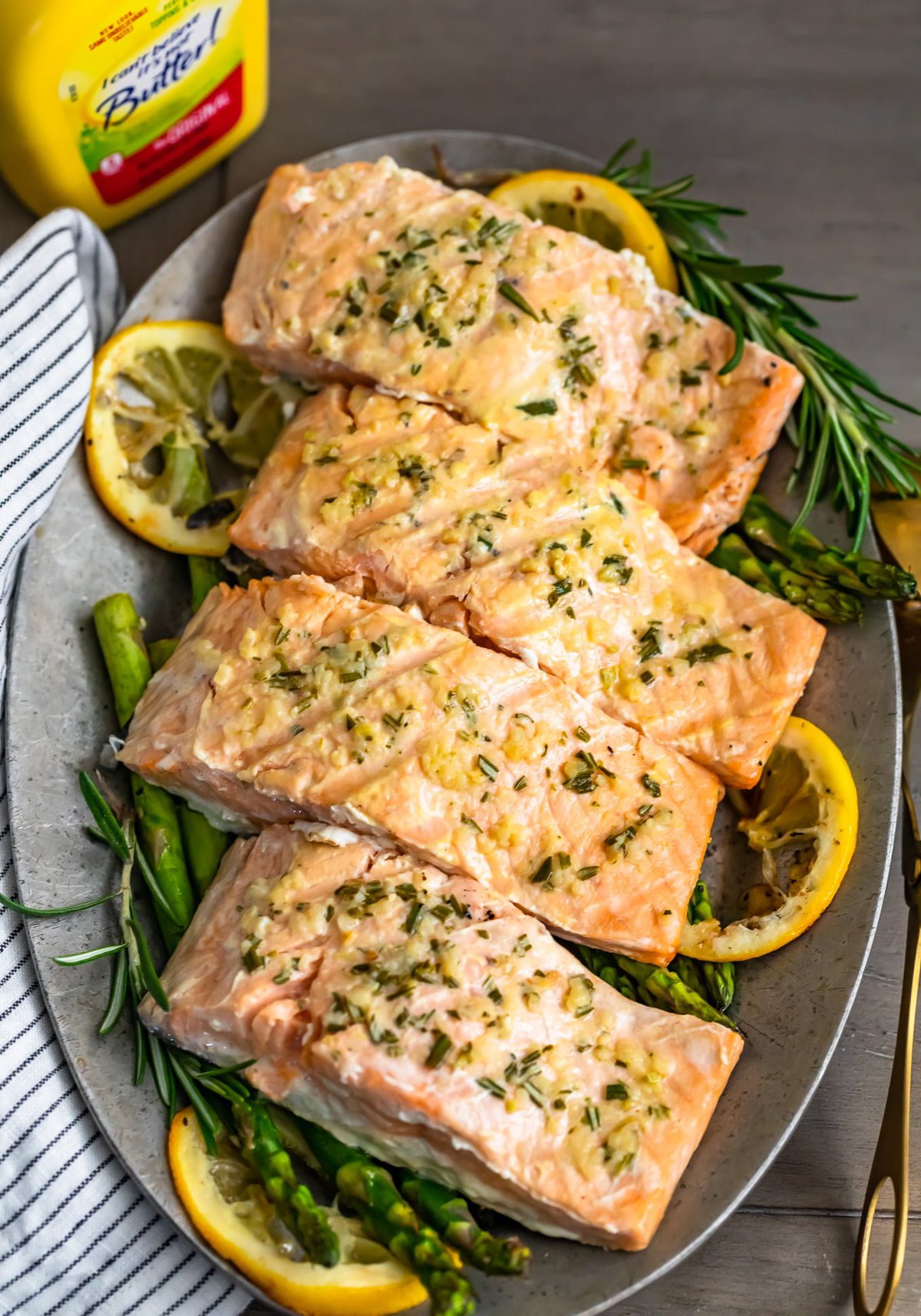 garlic lemon butter salmon on a plate of asparagus