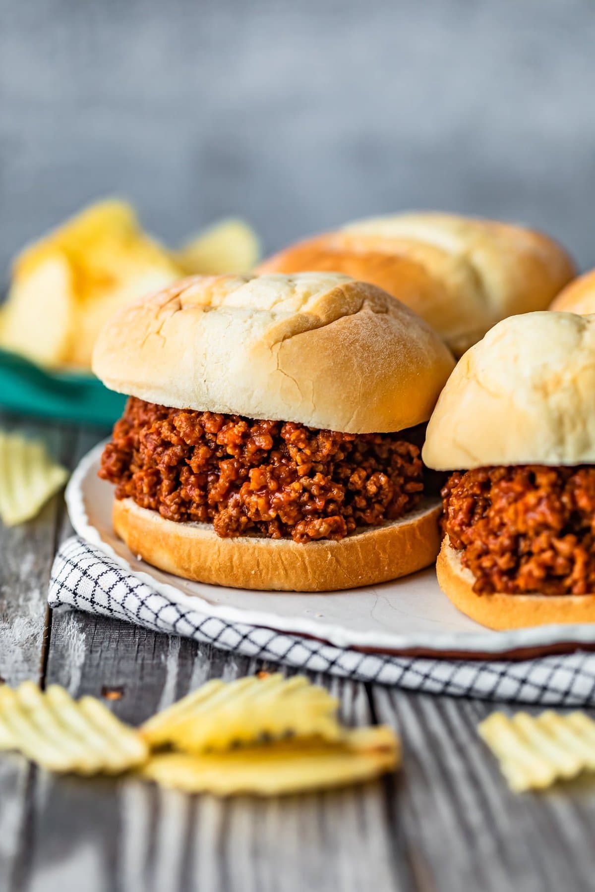 a plate of ground beef sloppy joes on a table top