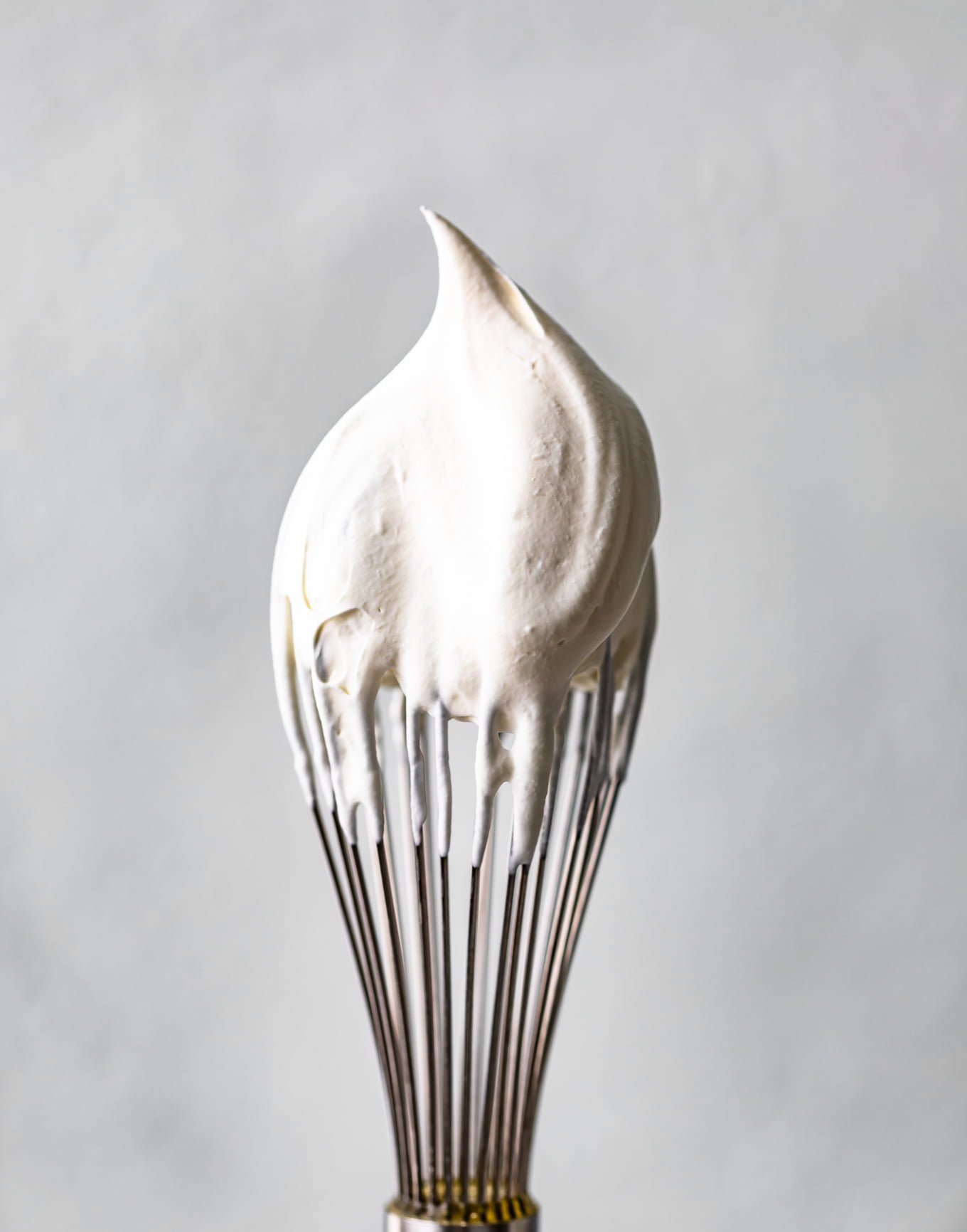 a whisk dipped in whipped cream