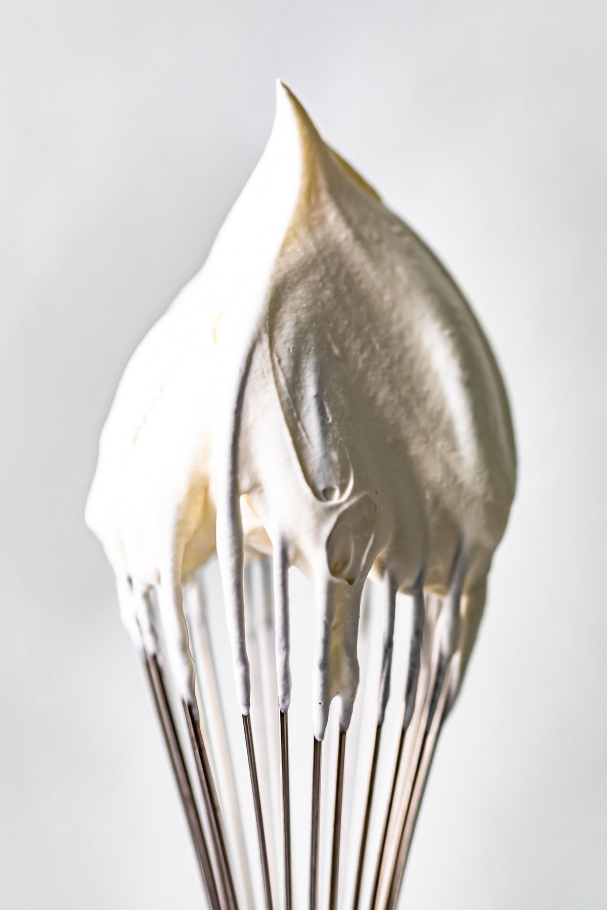 a whisk with whipped cream