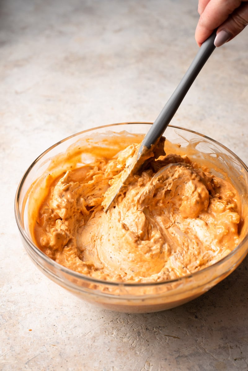 Mixing everything together in a bowl to make buffalo chicken dip