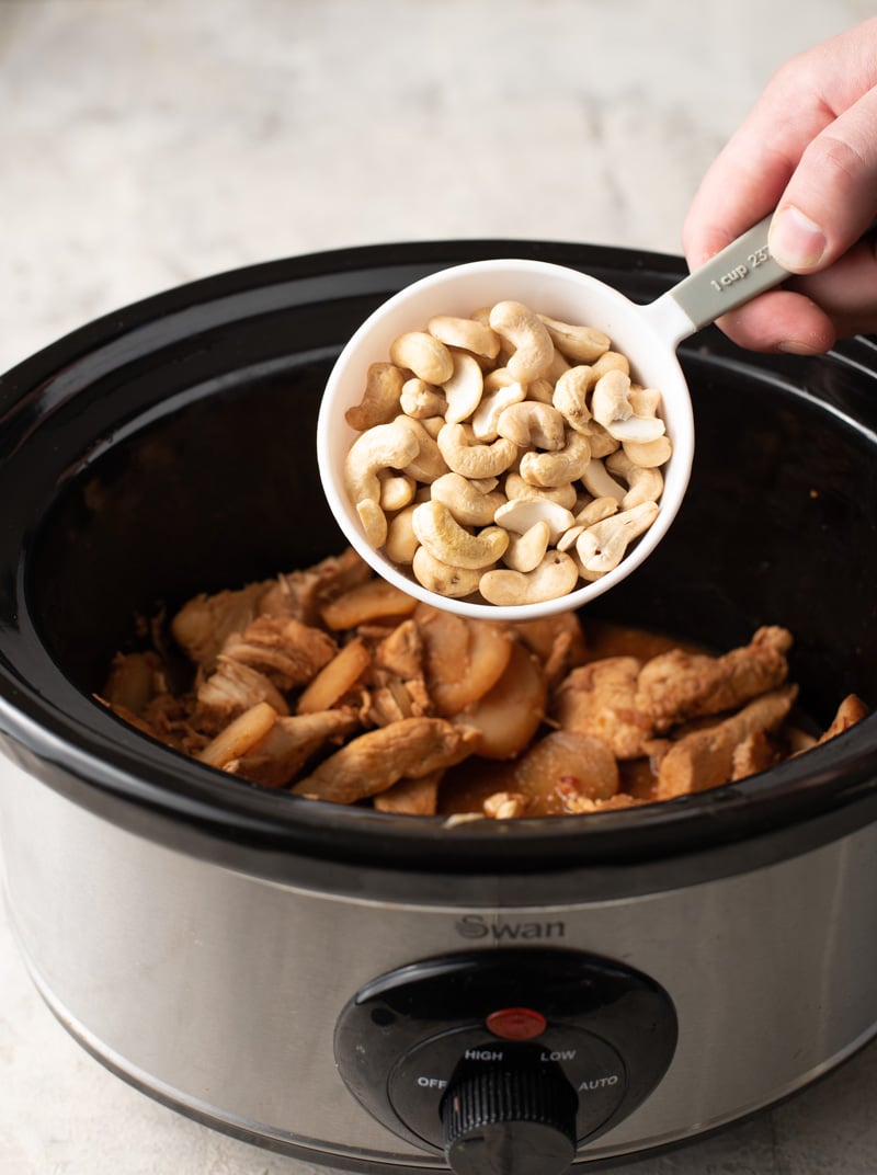 Adding cashew to a slow cooker to make cashew chicken