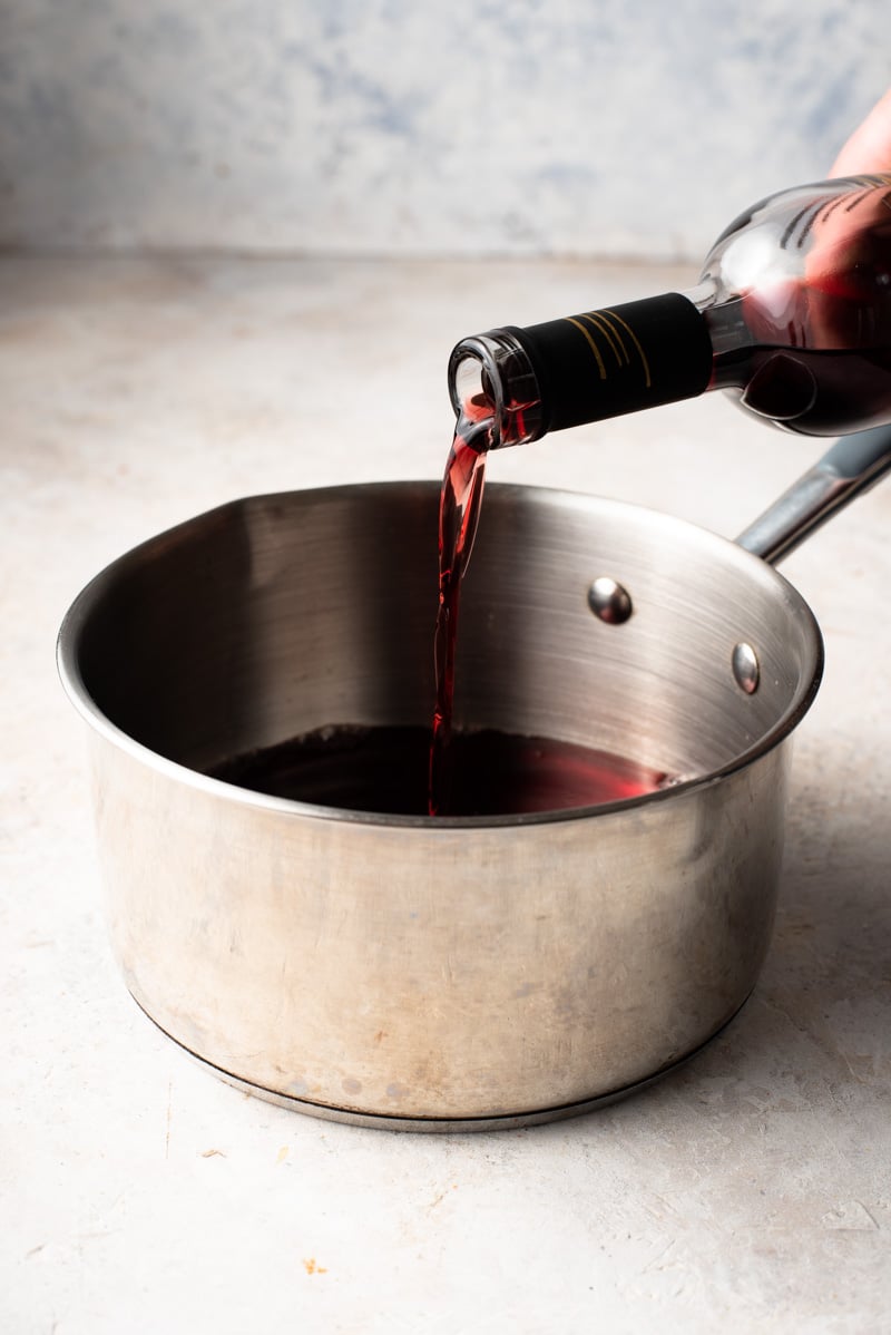 wine being poured in a sauce pan