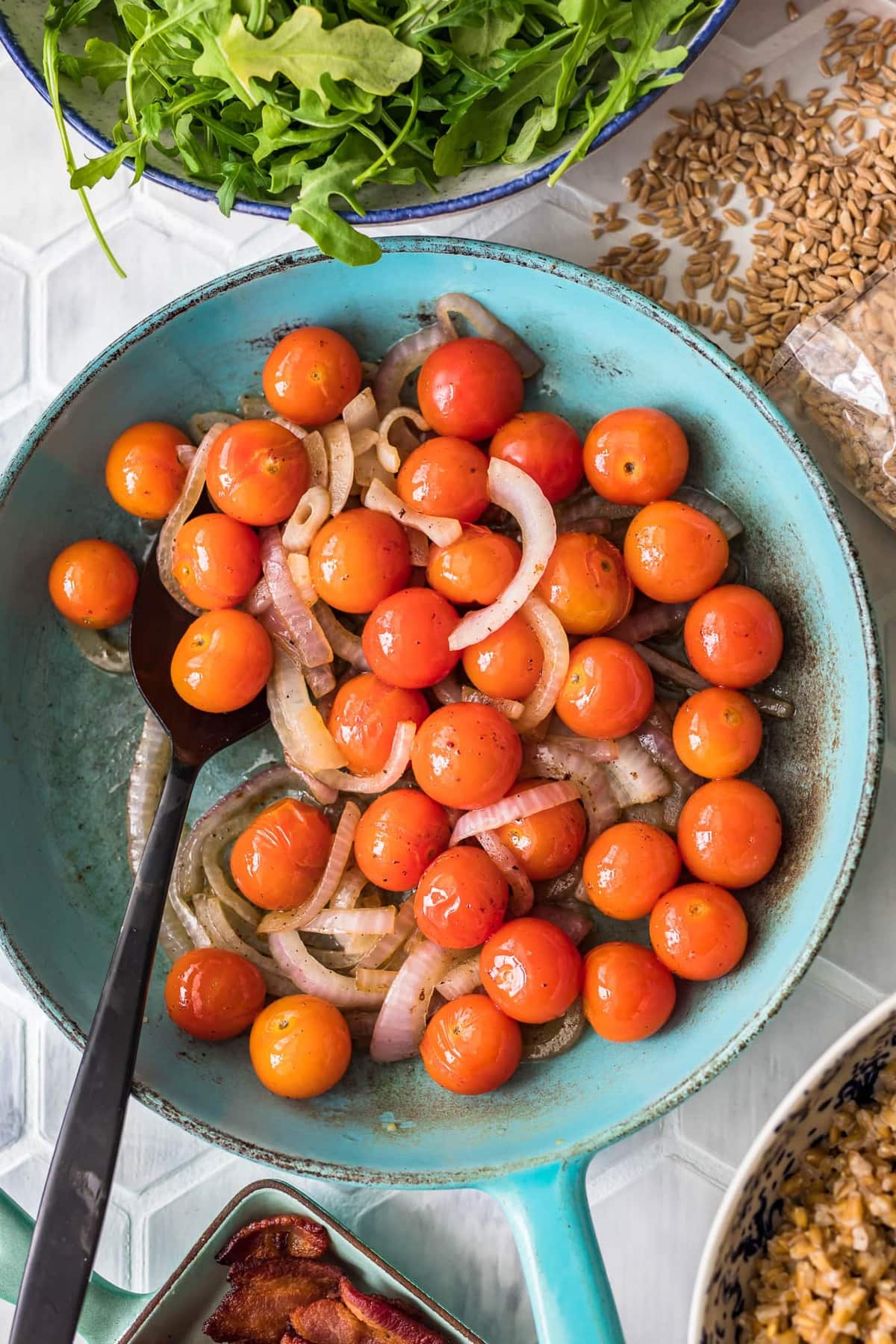 a bowl of cherry tomatoes and sliced onion