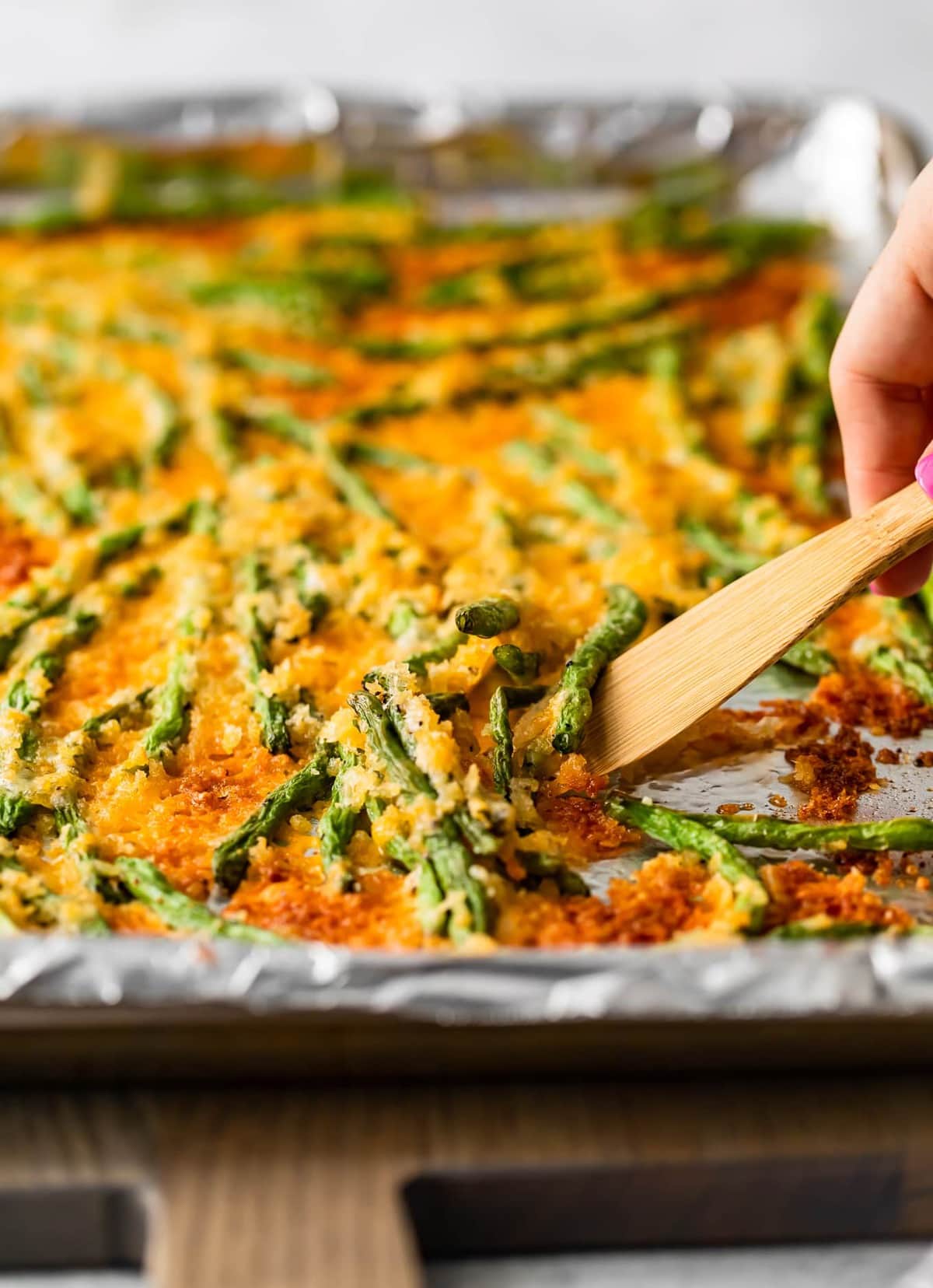 a spatula lifting up the cooked green beans