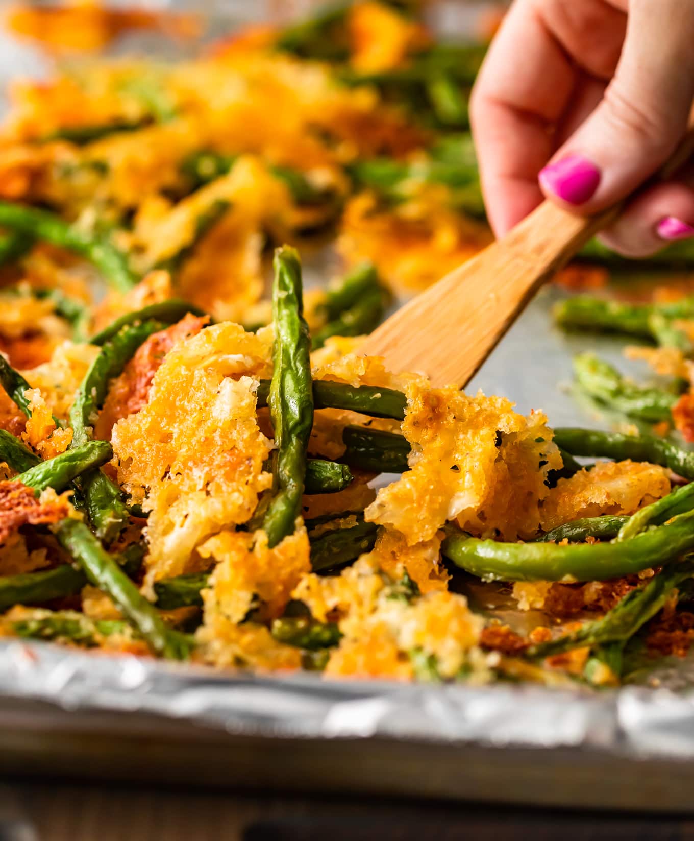 close up pf crispy baked green beans on a spatula