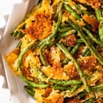 Crispy fried green beans served in a white bowl.