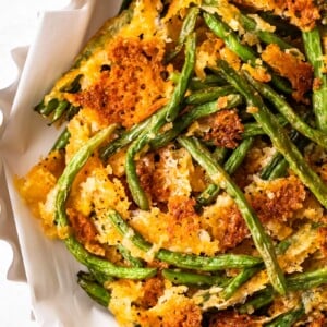 Crispy fried green beans served in a white bowl.