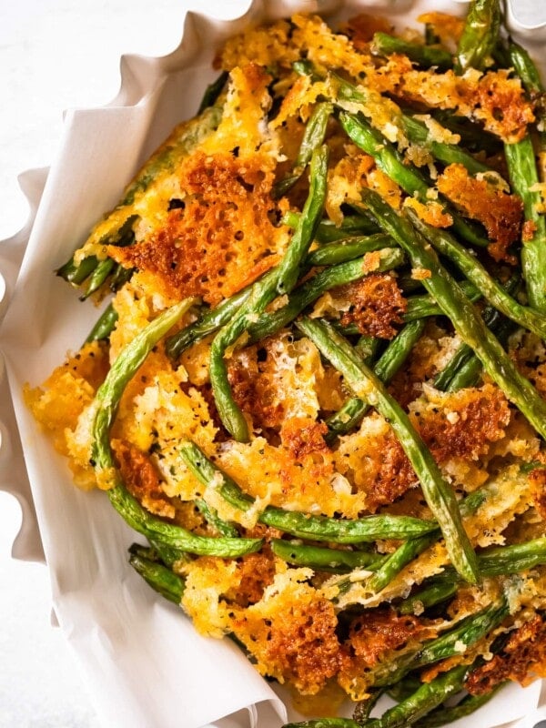 Crispy fried green beans served in a white bowl.