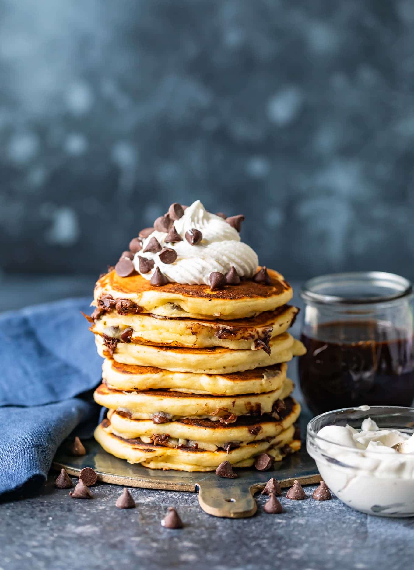 Chocolate chip pancakes topped with whipped cream and chocolate chips
