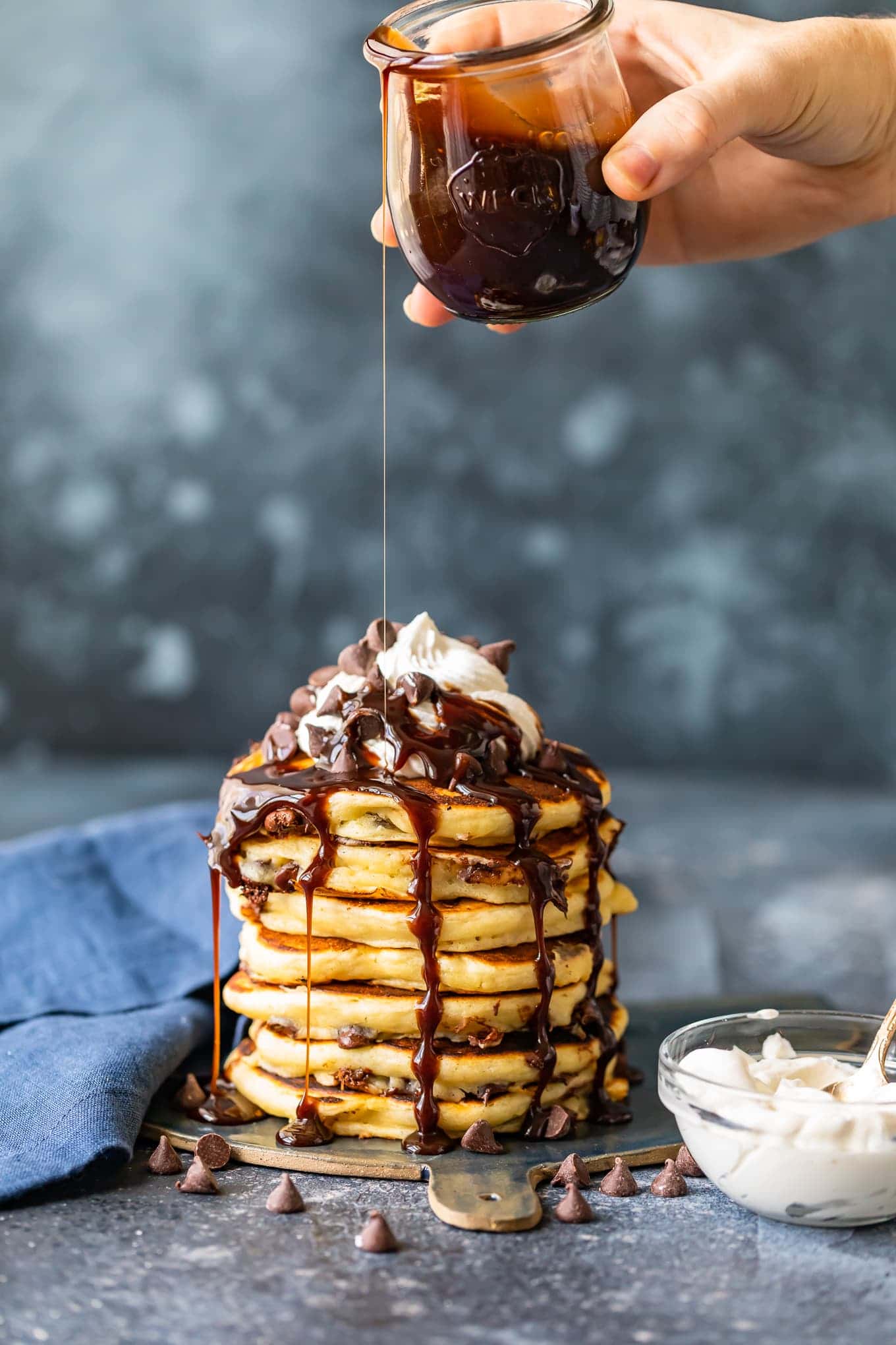 Chocolate chip pancakes with cream and chocolate syrup