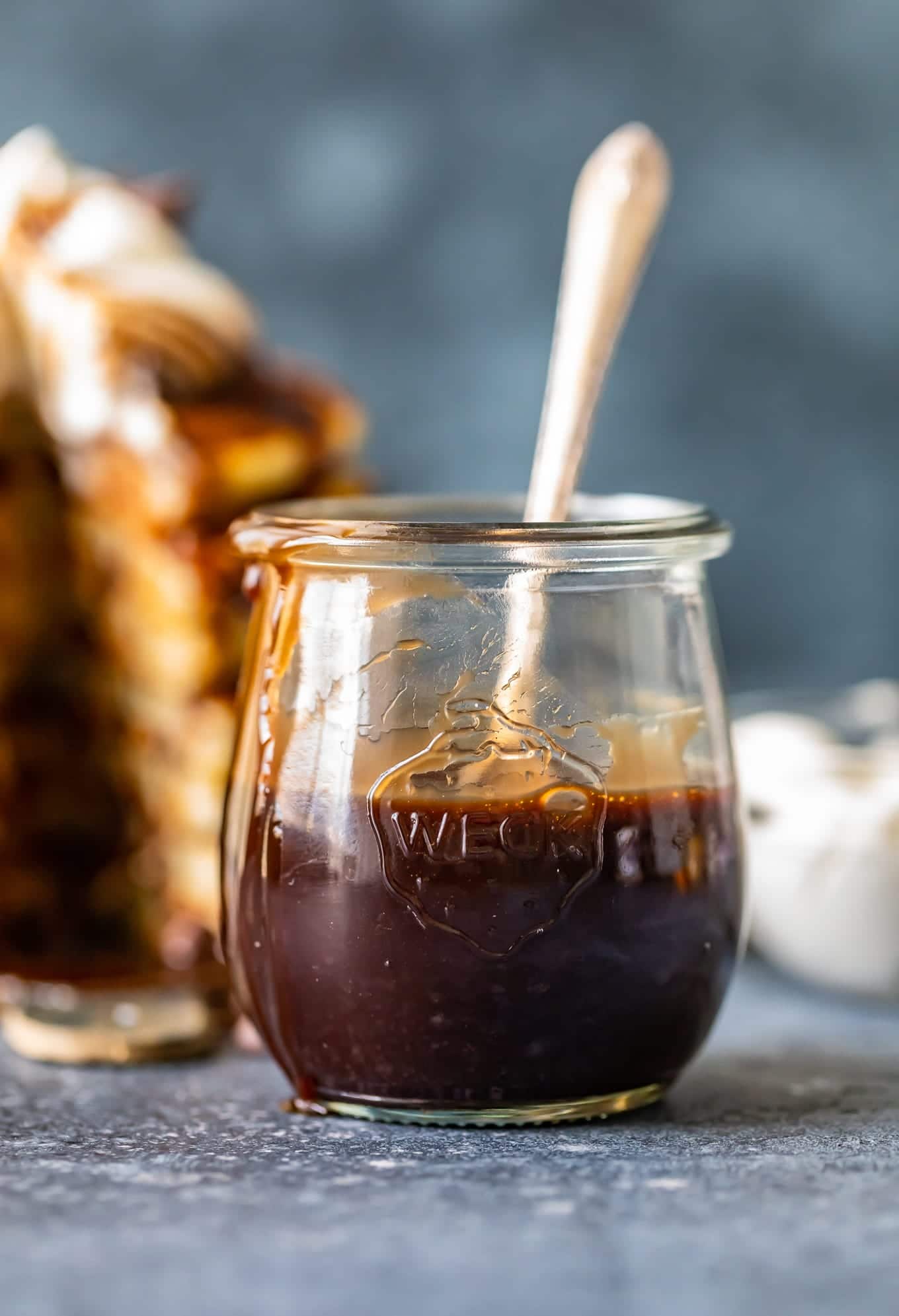 Chocolate sauce in a glass jar with a spoon