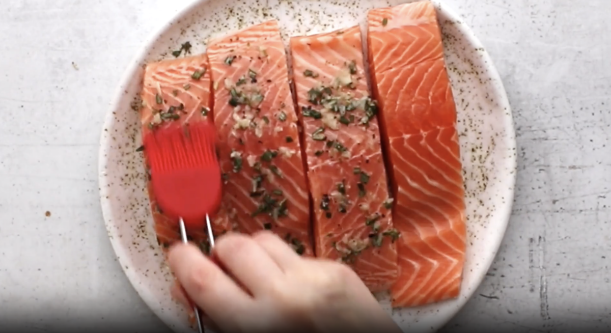 raw salmon filets spread with herbs.