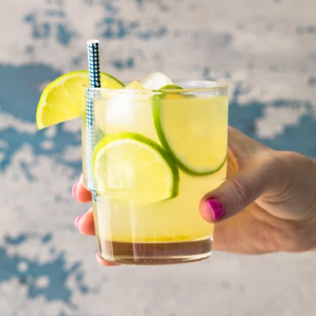 hand holding glass of homemade limeade