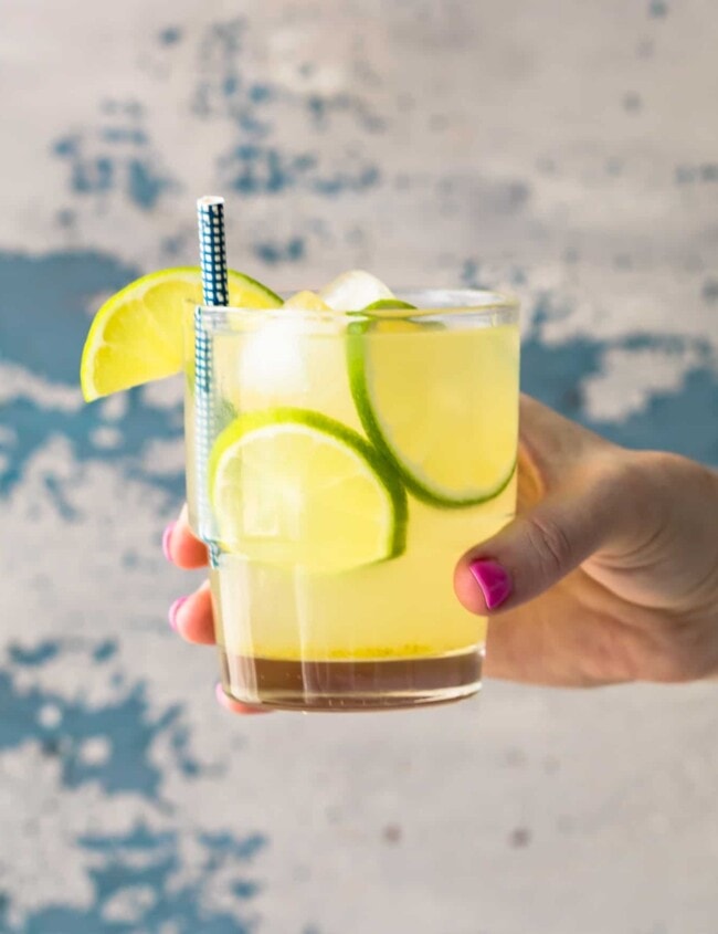 hand holding glass of homemade limeade