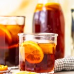 homemade sweat tea in a glass in front of a pitcher of sweet tea