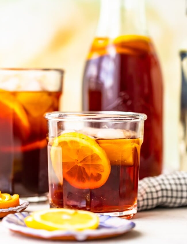 homemade sweat tea in a glass in front of a pitcher of sweet tea